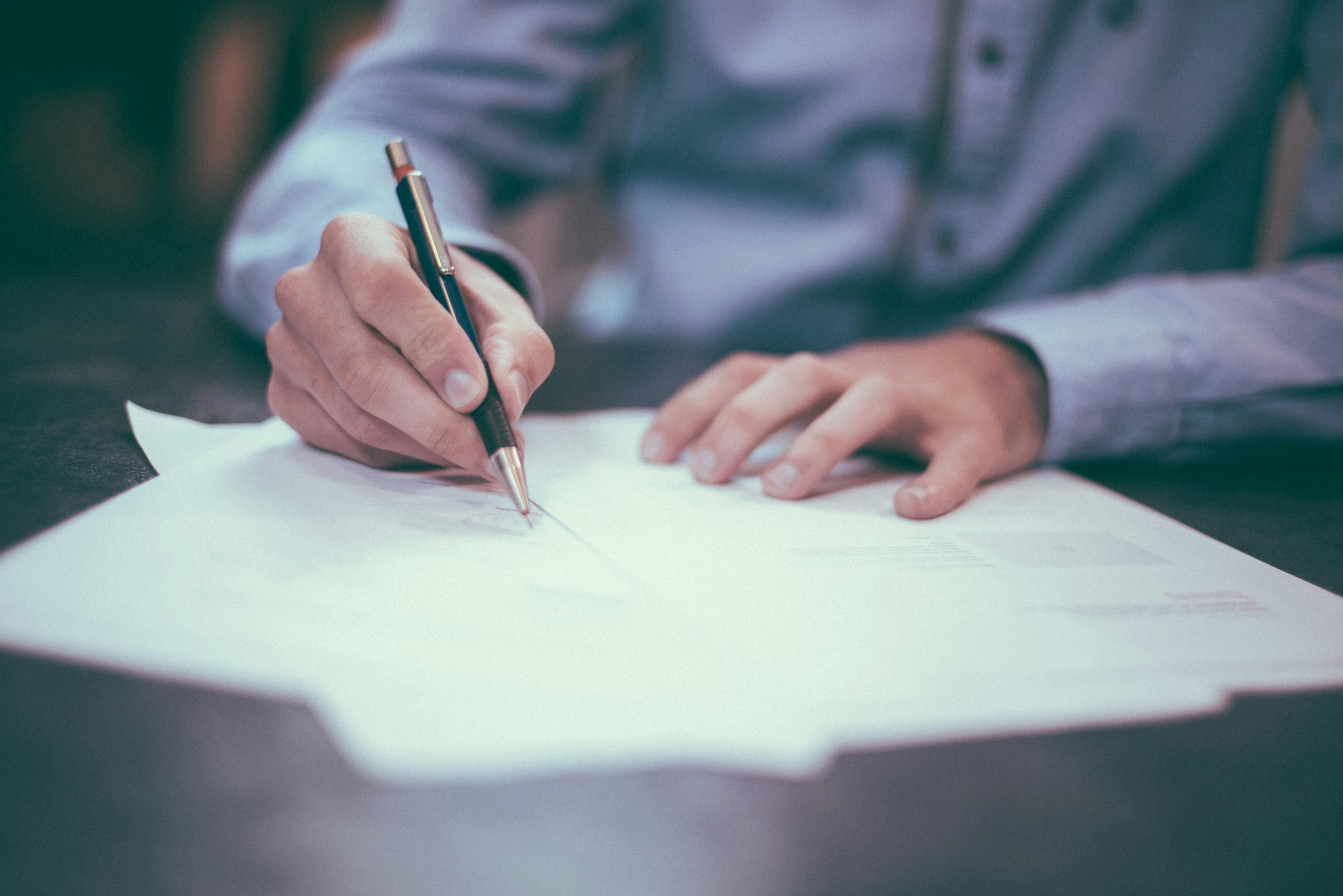 Signing paperwork at a desk