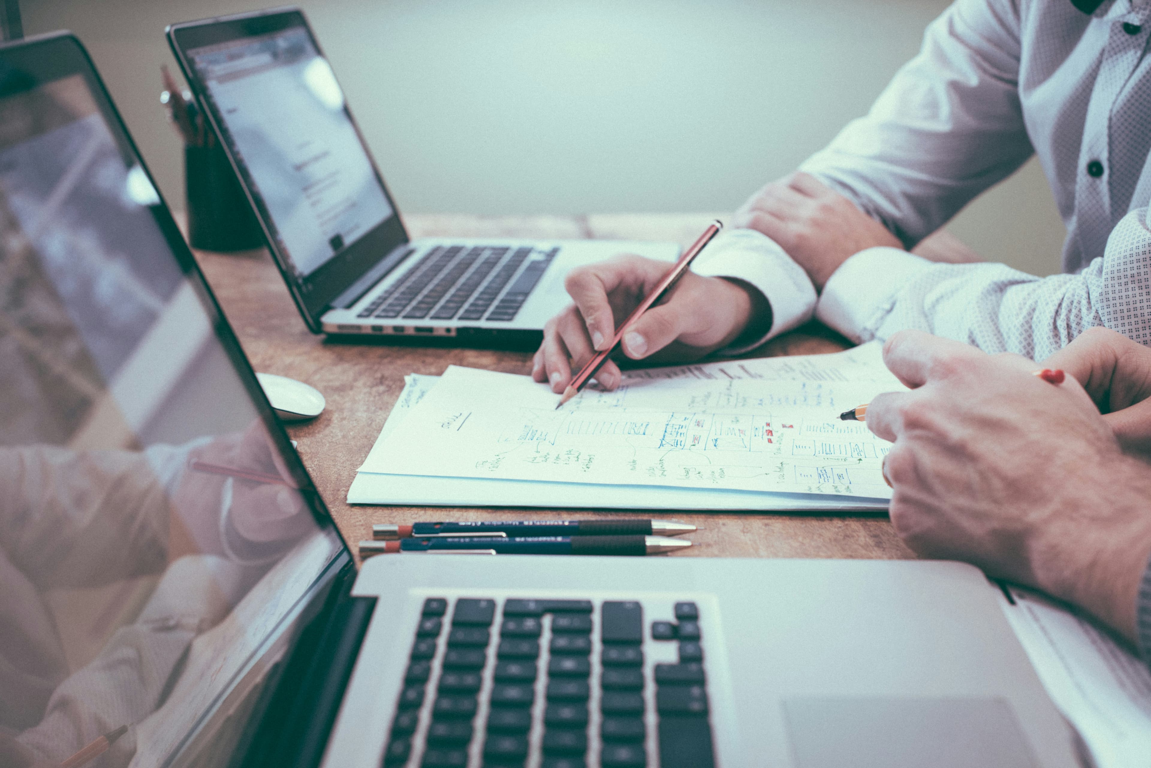 Two colleagues reviewing financial reports together at a desk
