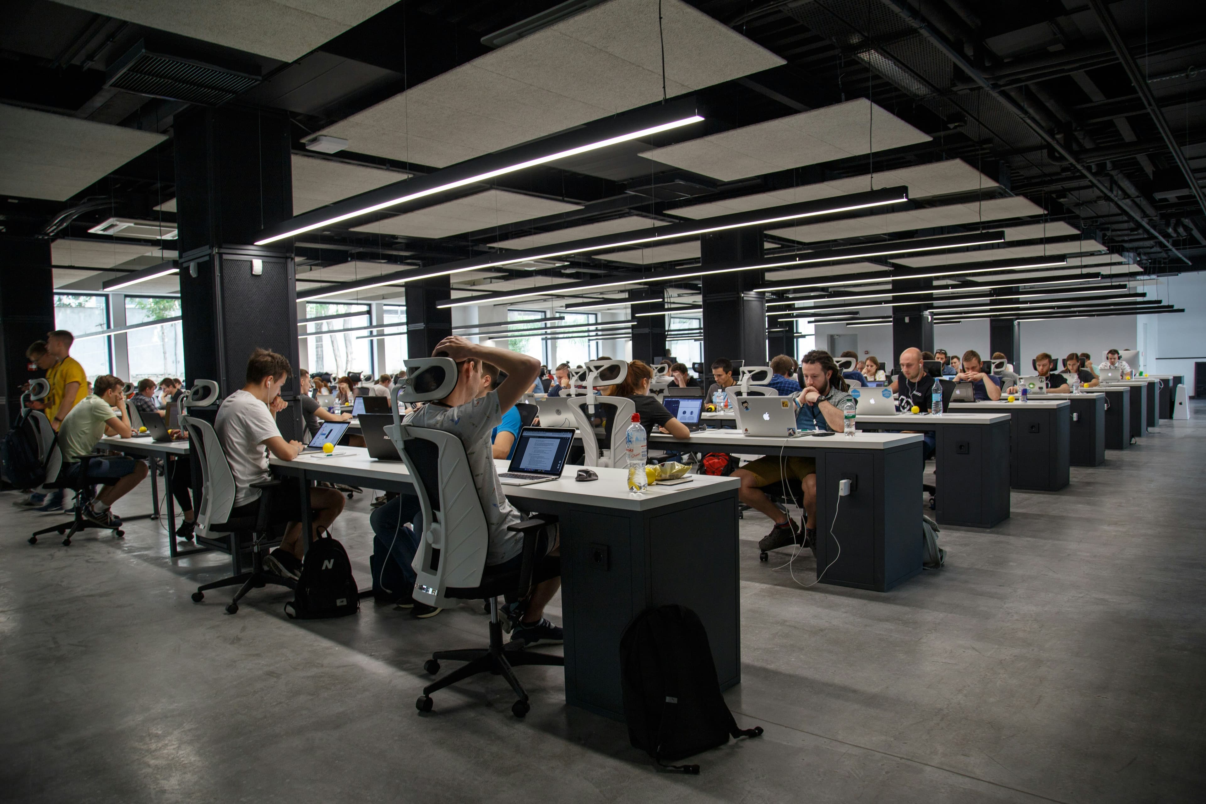Open-plan workplace with staff across many desks
