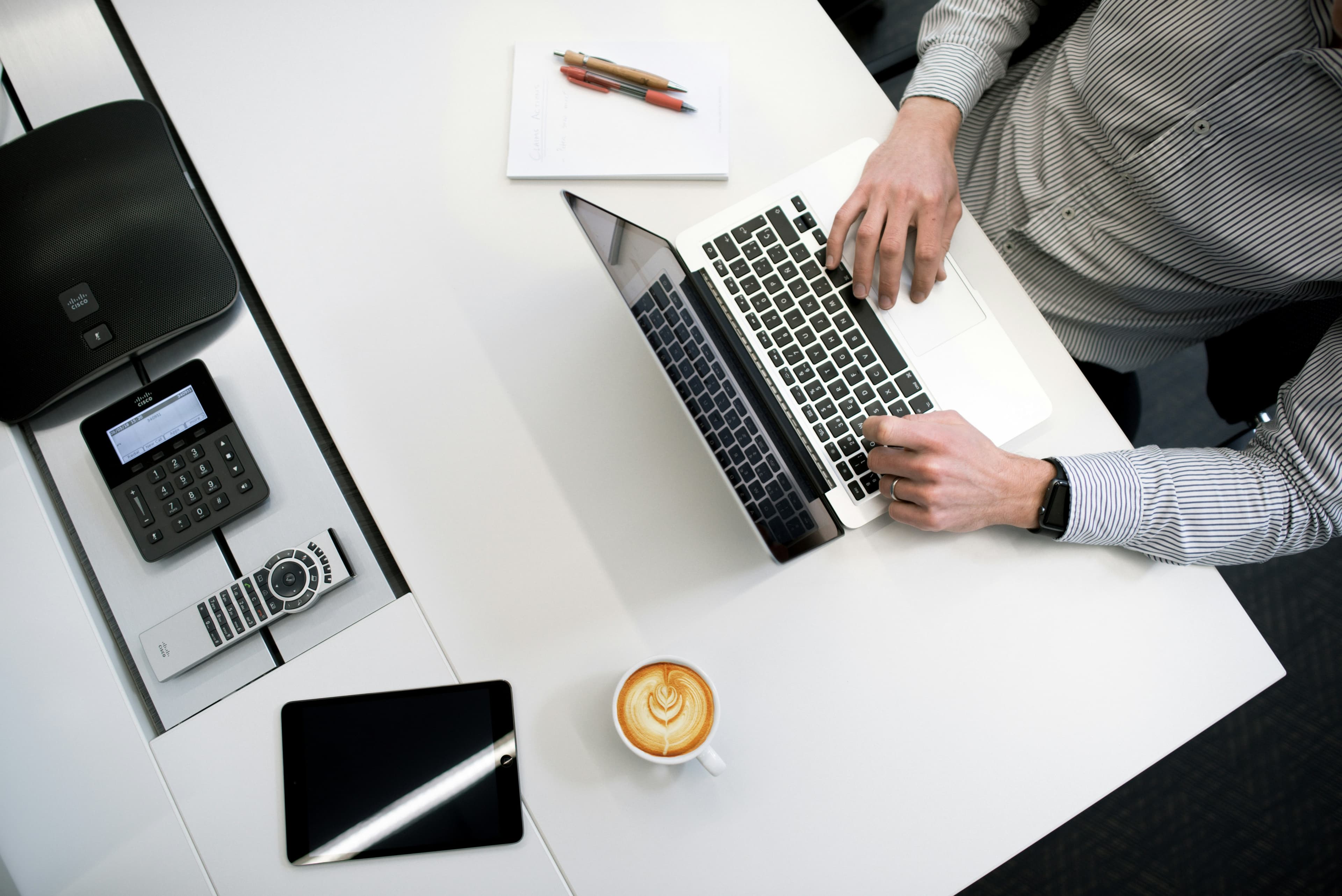 Desk with paperwork, phone and laptop during a bookkeeping session