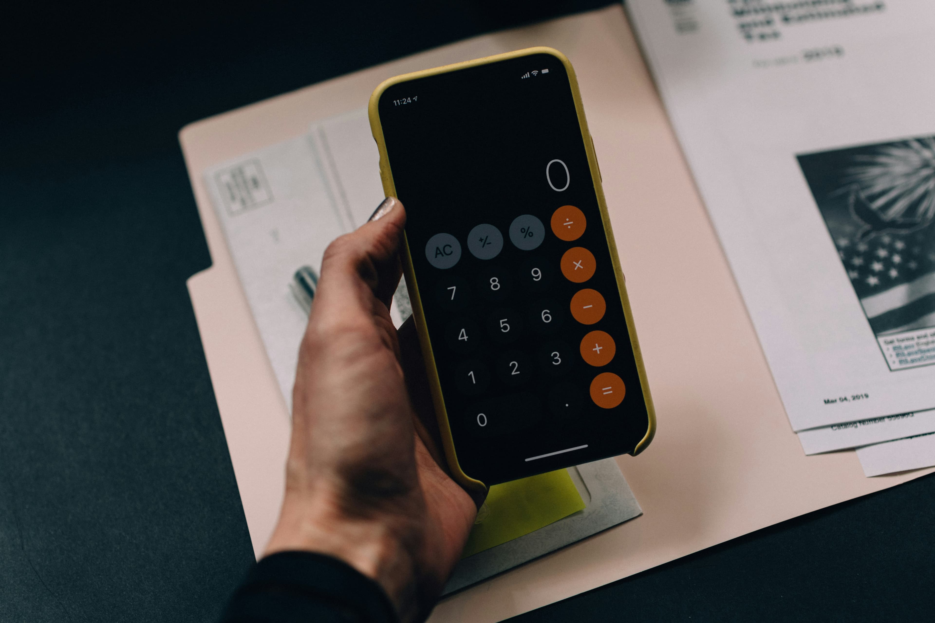 Calculator resting on a stack of invoices
