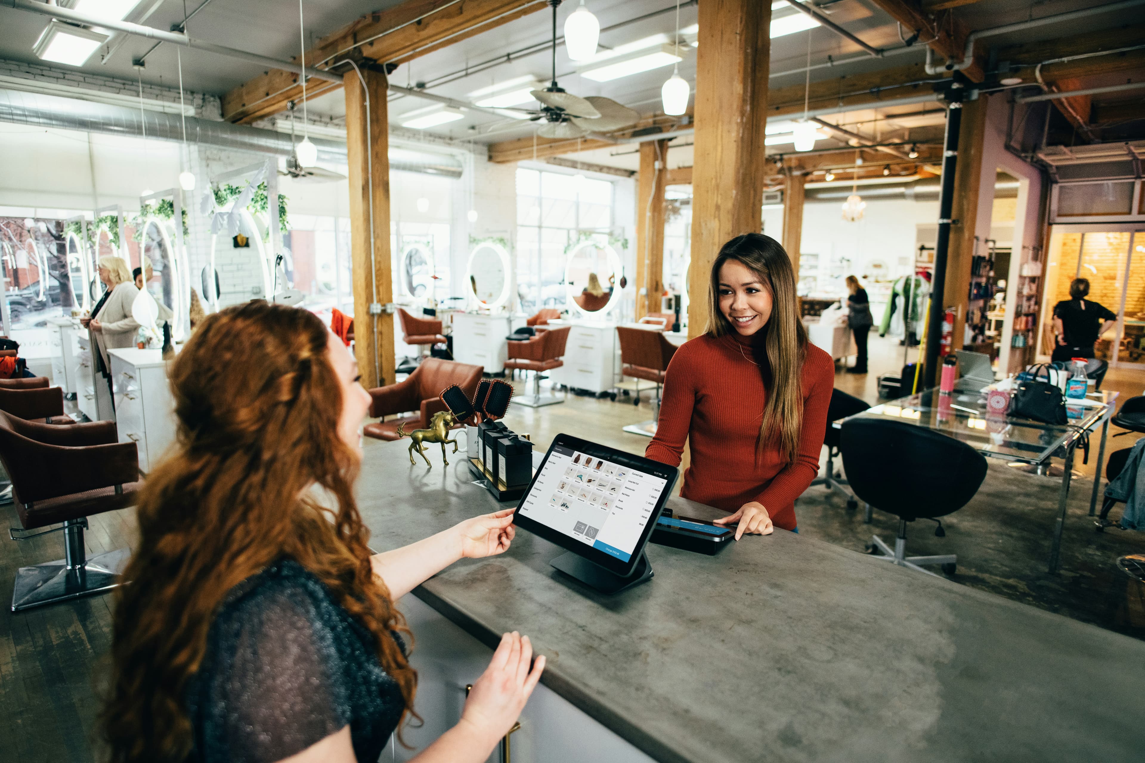 A retailer completing a sale at the checkout counter